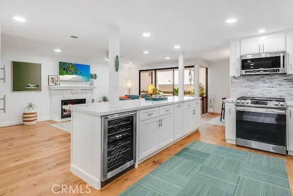 a kitchen with stainless steel appliances a stove sink and microwave