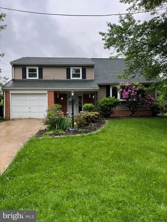 a front view of a house with a garden and plants
