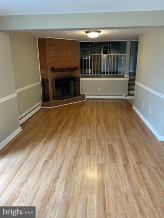 wooden floor in an empty room with a fireplace