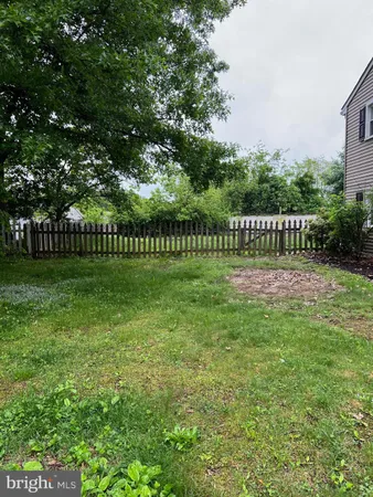 a view of a park with a fence and trees