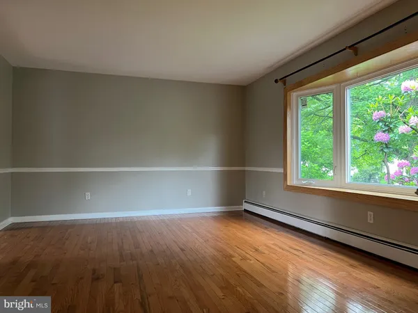 a view of wooden floor and windows in a room