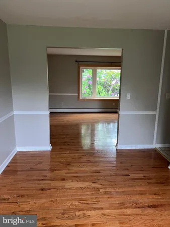 a view of room with window and wooden floor