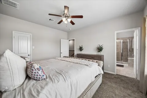 a bedroom with a large bed and a chandelier