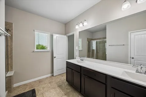 a bathroom with a double vanity sink and mirror