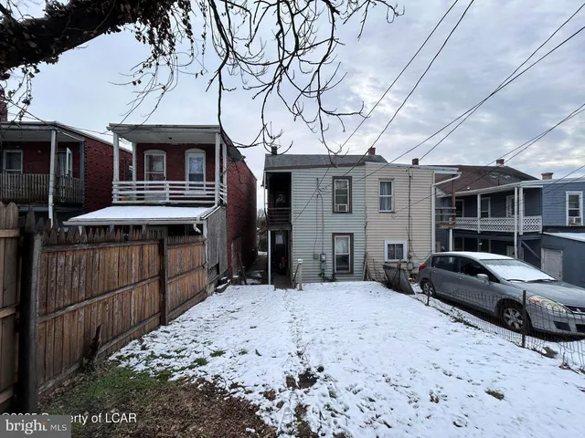 a view of a house with a snow in the yard