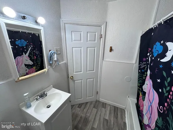 a bathroom with a sink mirror and vanity