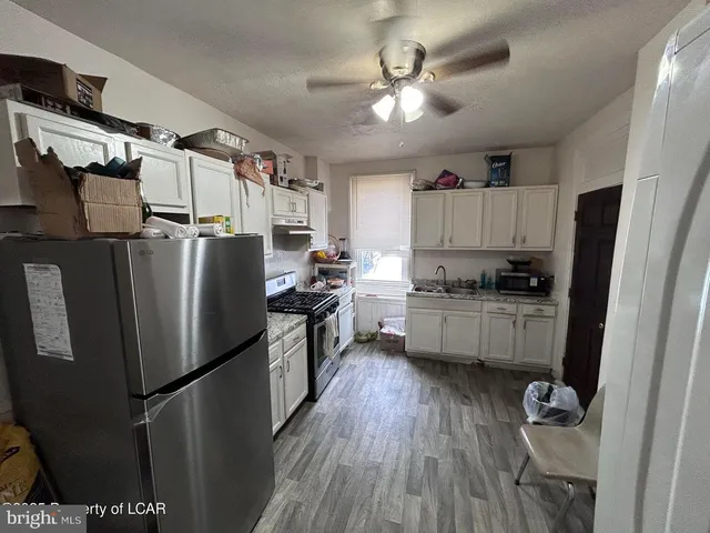 a kitchen with stainless steel appliances a refrigerator a sink a stove a microwave and cabinets