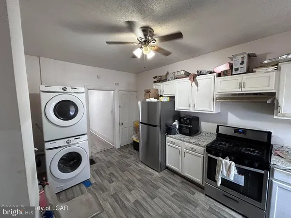 a kitchen with stainless steel appliances granite countertop a stove a refrigerator and a sink