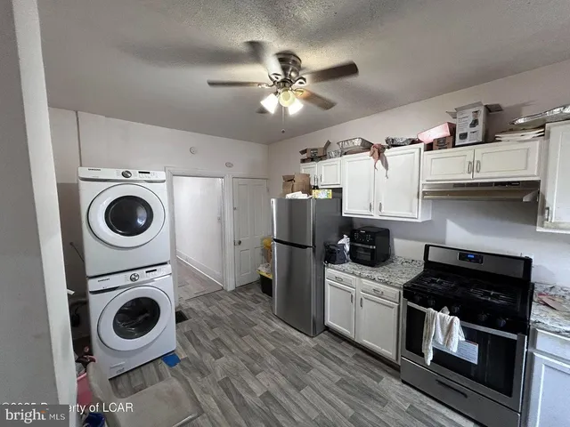 a kitchen with stainless steel appliances granite countertop a stove a refrigerator and a sink