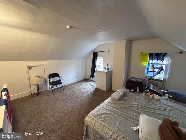 a bedroom with a bed and a desk