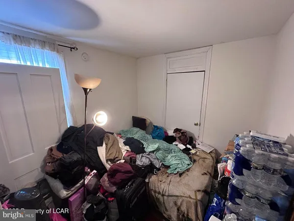 a bed room with bed and a lamp