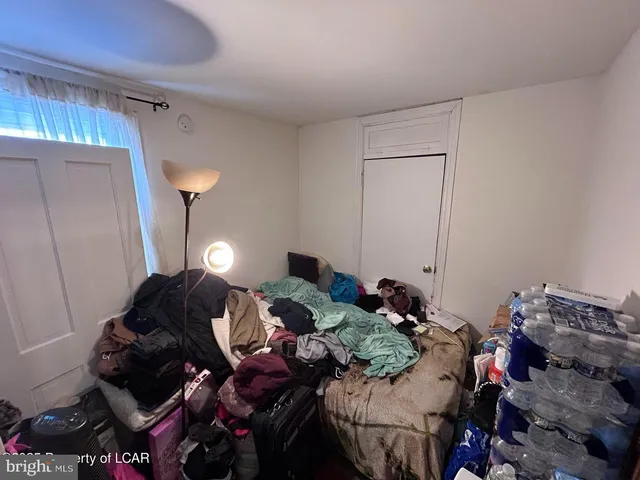 a bed room with bed and a lamp