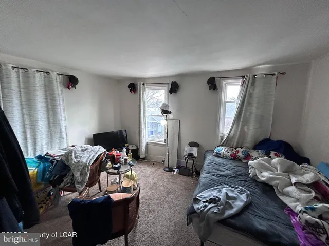 a bedroom with furniture and a window