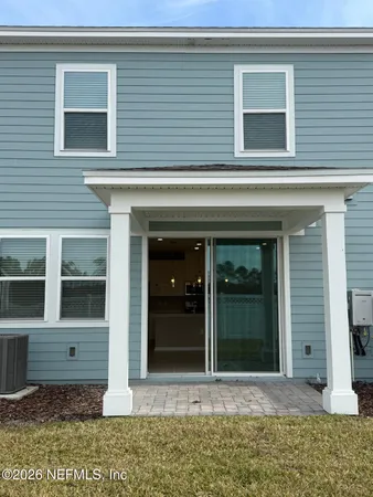 a white toilet sitting next to a white wall