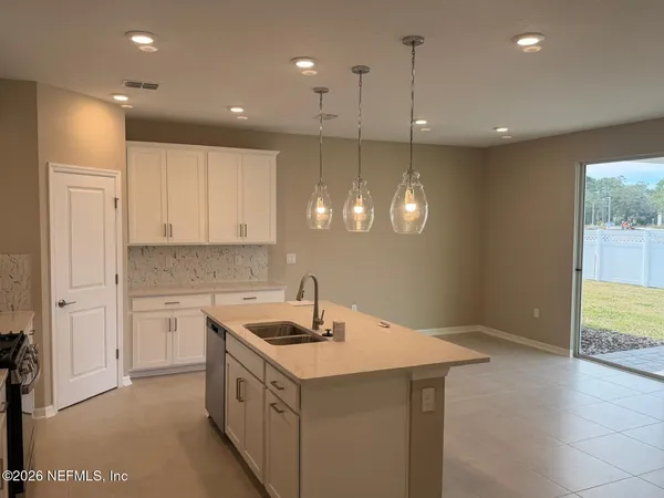 a kitchen with a sink and chandelier