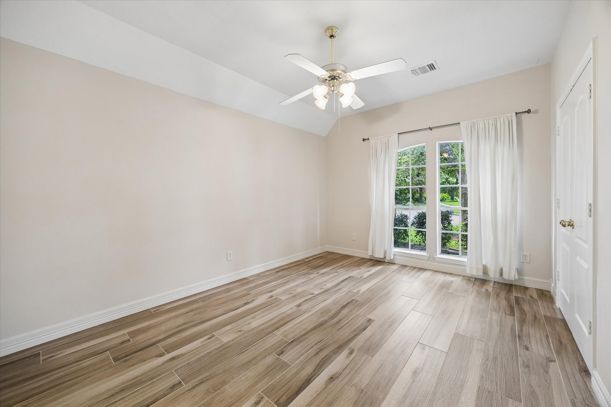 5306 Summerland Ridge Court Houston, TX 77041 - Photo 21 of 33 an empty room with wooden floor fan and windows