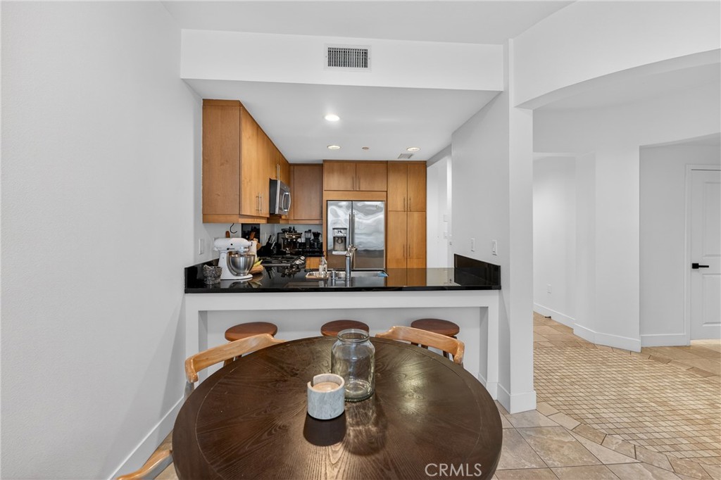 150 The Promenade North, Unit 415 Long Beach, CA 90802 - Photo 13 of 46 a kitchen with a table and chairs in it