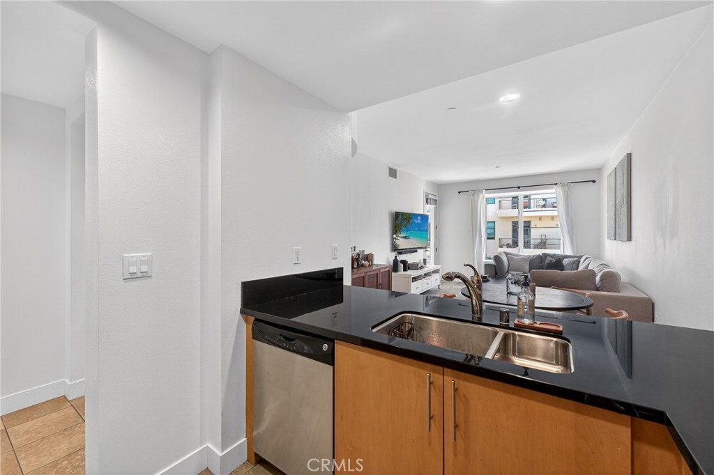 150 The Promenade North, Unit 415 Long Beach, CA 90802 - Photo 15 of 46 a kitchen with granite countertop a sink and cabinets