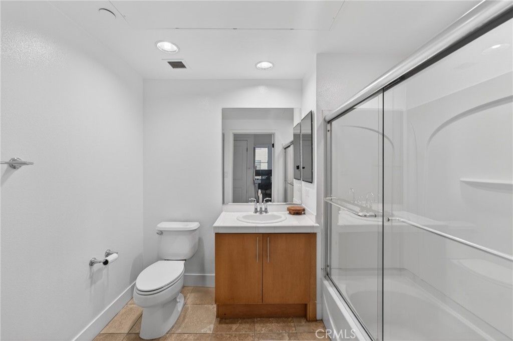 150 The Promenade North, Unit 415 Long Beach, CA 90802 - Photo 21 of 46 a bathroom with a granite countertop sink toilet and shower