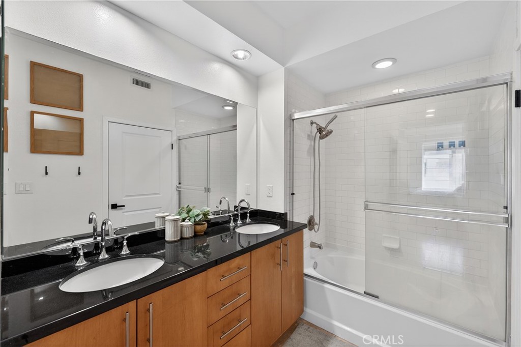 150 The Promenade North, Unit 415 Long Beach, CA 90802 - Photo 27 of 46 a bathroom with a granite countertop sink mirror and double