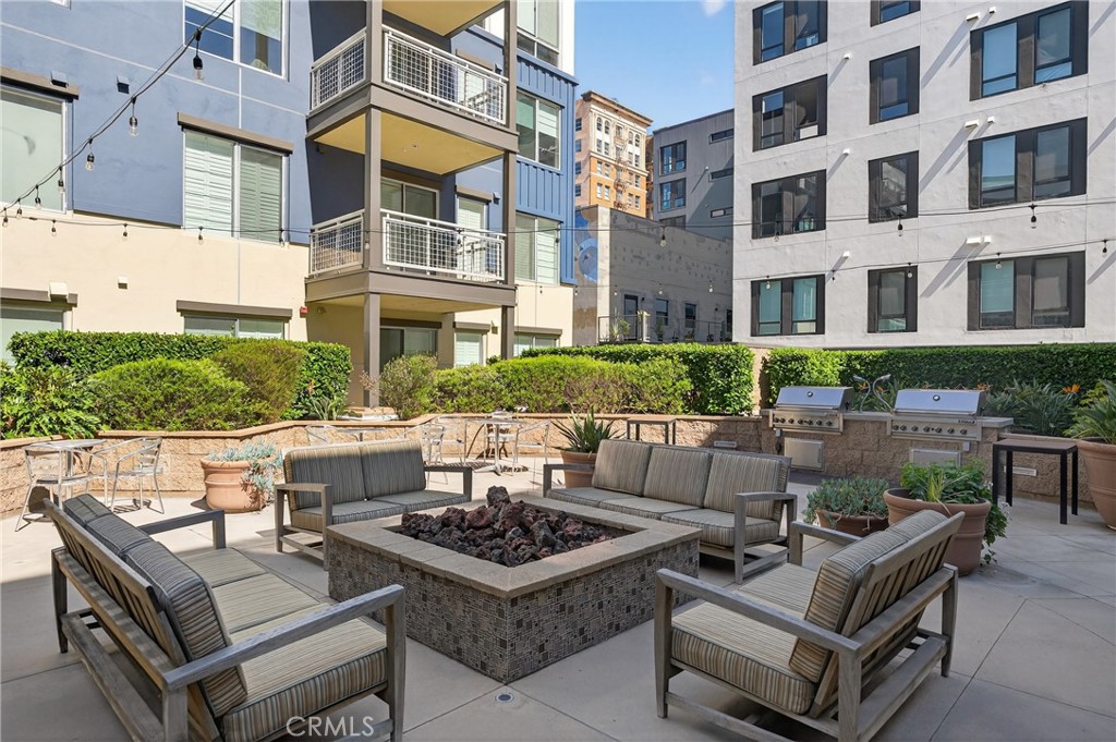 150 The Promenade North, Unit 415 Long Beach, CA 90802 - Photo 35 of 46 a view of a patio with couches table and chairs and potted plants