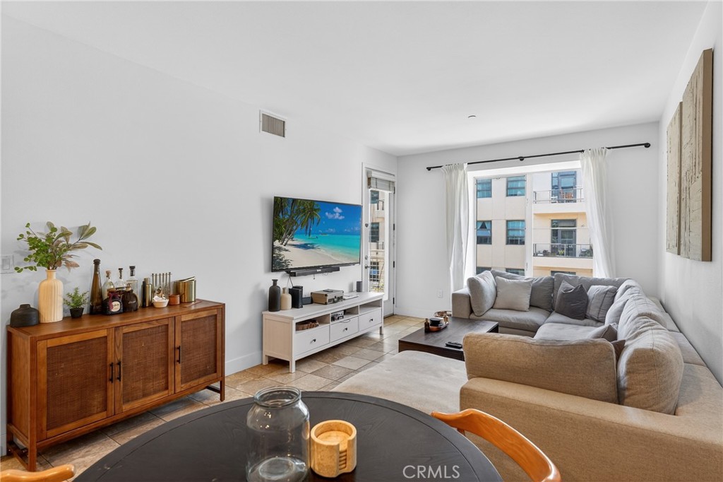 150 The Promenade North, Unit 415 Long Beach, CA 90802 - Photo 6 of 46 a living room with furniture and a flat screen tv
