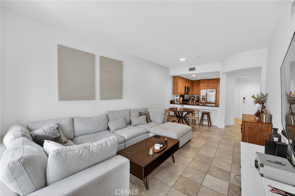 150 The Promenade North, Unit 415 Long Beach, CA 90802 - Photo 8 of 46 a living room with furniture and a couch