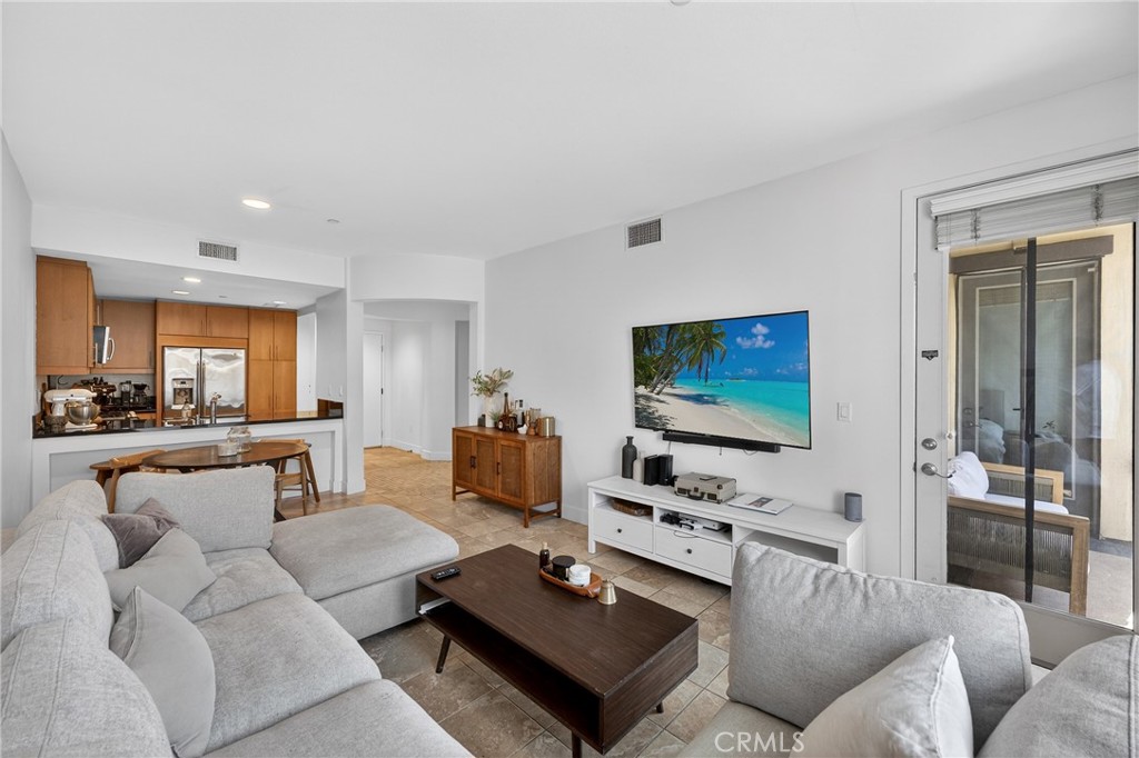 150 The Promenade North, Unit 415 Long Beach, CA 90802 - Photo 9 of 46 a living room with furniture and a flat screen tv