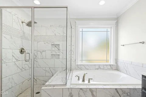 a white bath tub sitting next to a shower