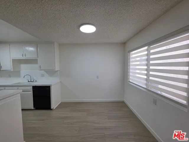 a view of a kitchen with a sink cabinets and a window