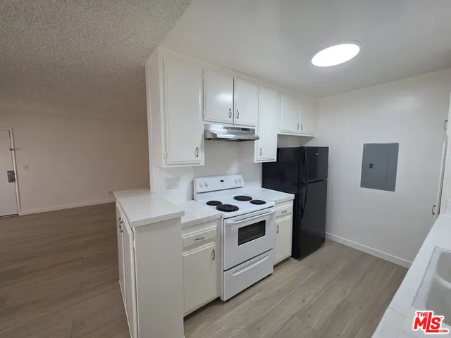 a kitchen with a stove and a refrigerator