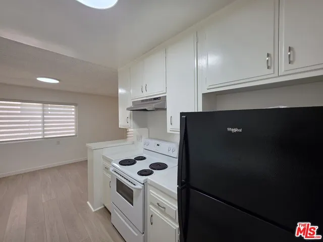 a kitchen with a stove and a refrigerator