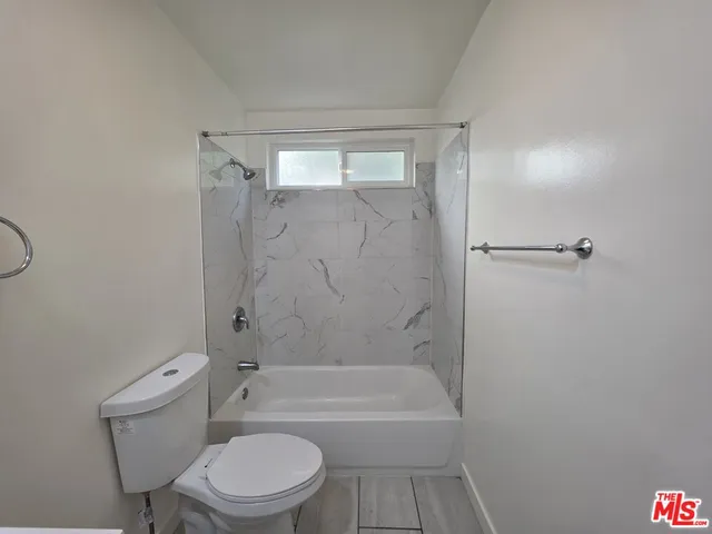 a bathroom with a toilet and a bathtub