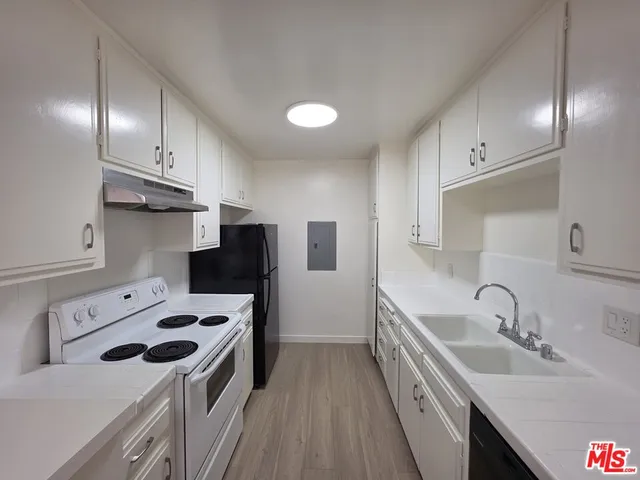 a kitchen with a sink a stove and refrigerator