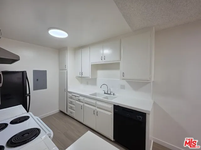a kitchen with a sink stainless steel appliances and cabinets