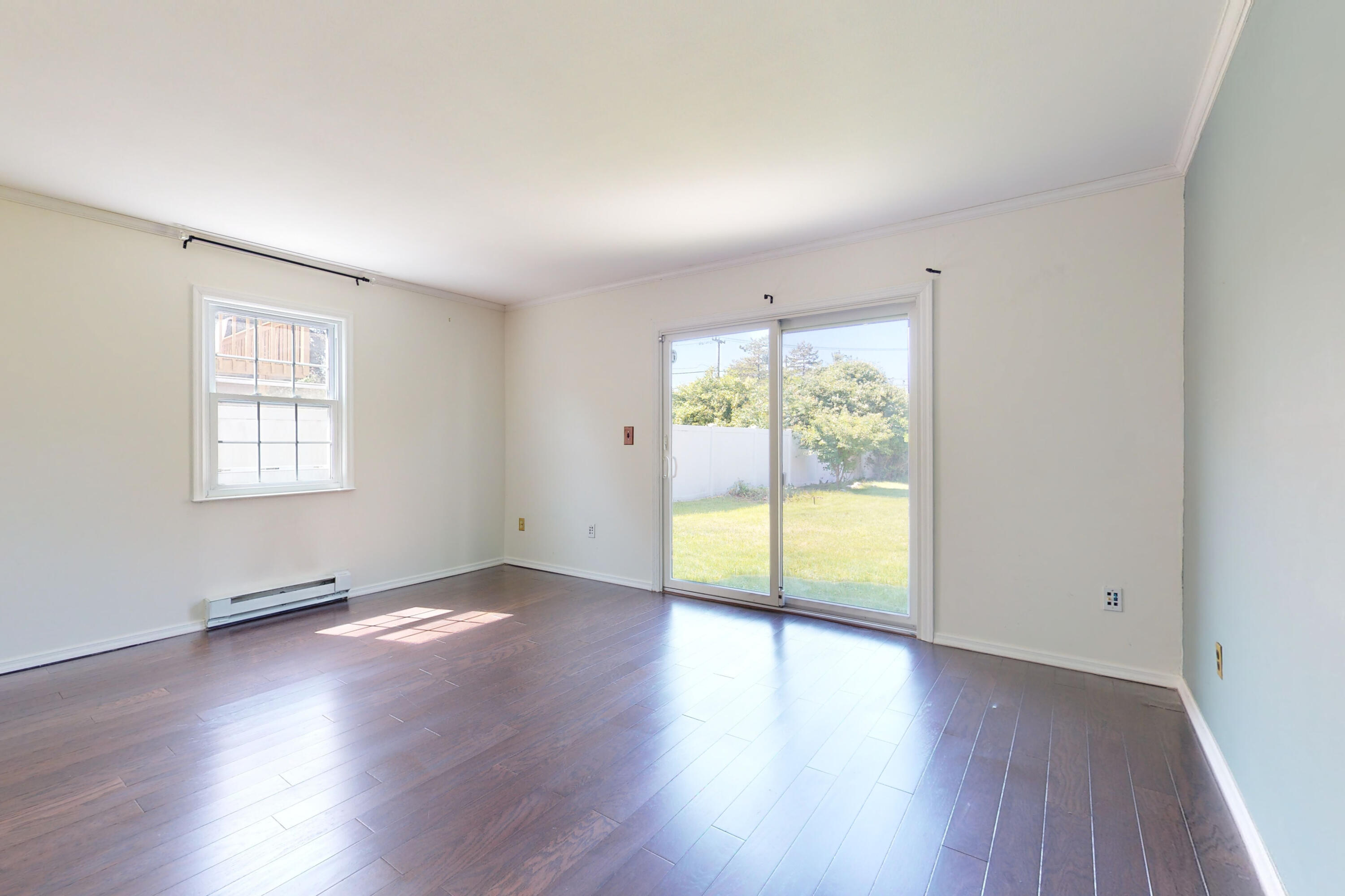 47 Mitchell Street Stamford, CT 06902 - Photo 17 of 22 an empty room with wooden floor and windows