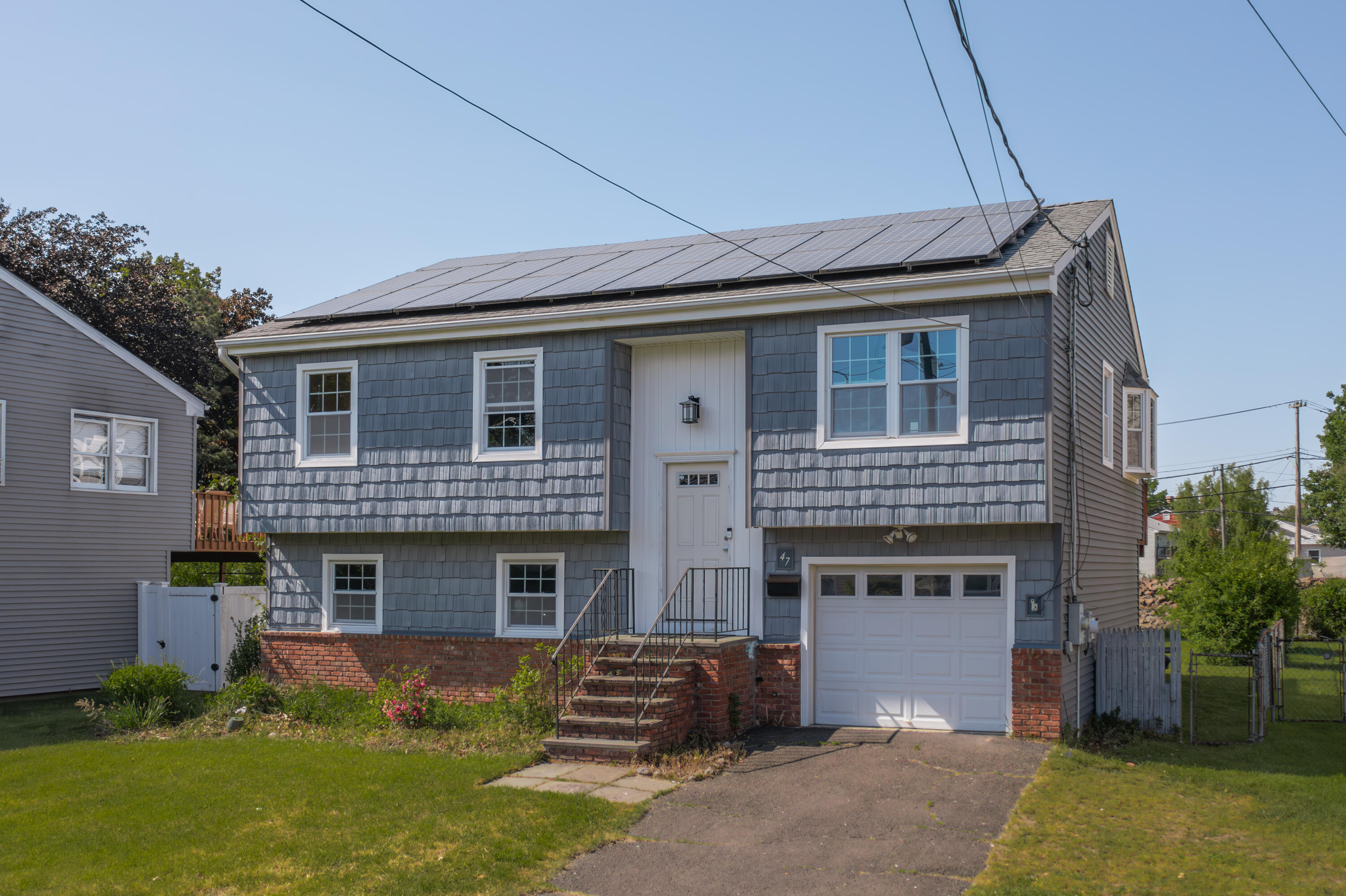 47 Mitchell Street Stamford, CT 06902 - Photo 2 of 22 a front view of a house with garden