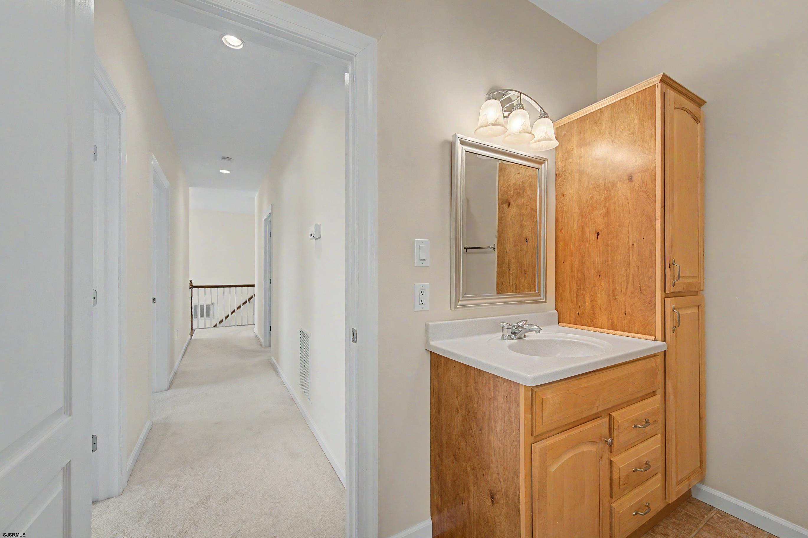 212 17th Street South Brigantine, NJ 08203 - Photo 27 of 37 a bathroom with a sink a mirror and a shower