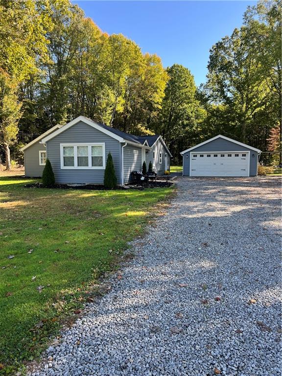 a front view of a house with a yard and trees