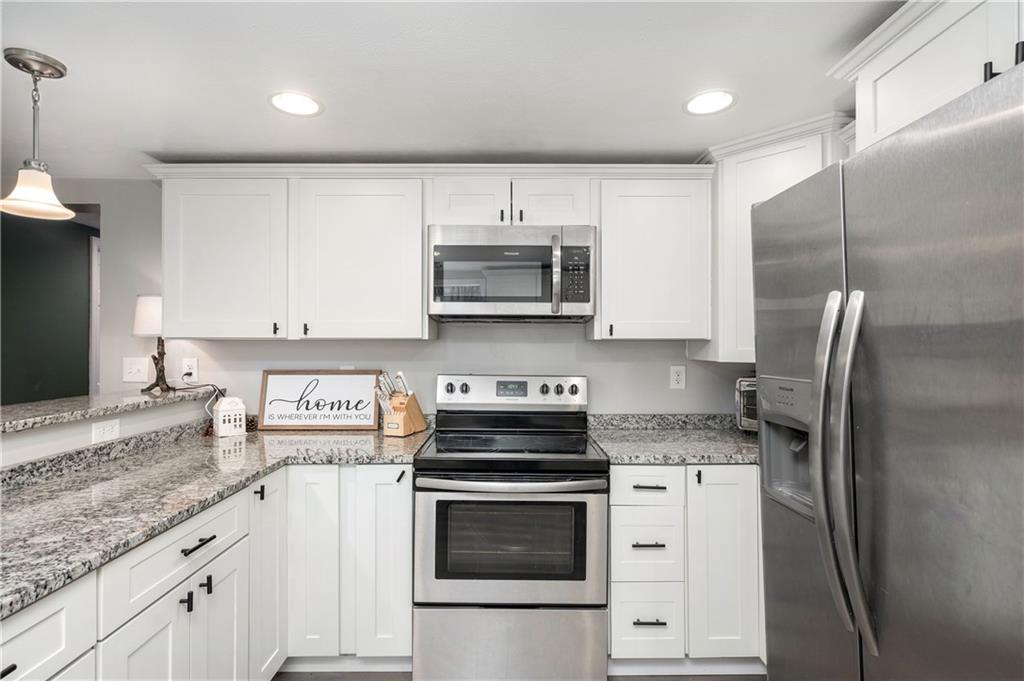 100 Blom Road Grove City, PA 16127 - Photo 16 of 31 a kitchen with stainless steel appliances granite countertop a stove a refrigerator and a white cabinets