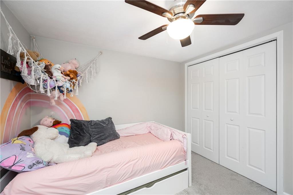 100 Blom Road Grove City, PA 16127 - Photo 25 of 31 a bedroom with a bed and a chandelier