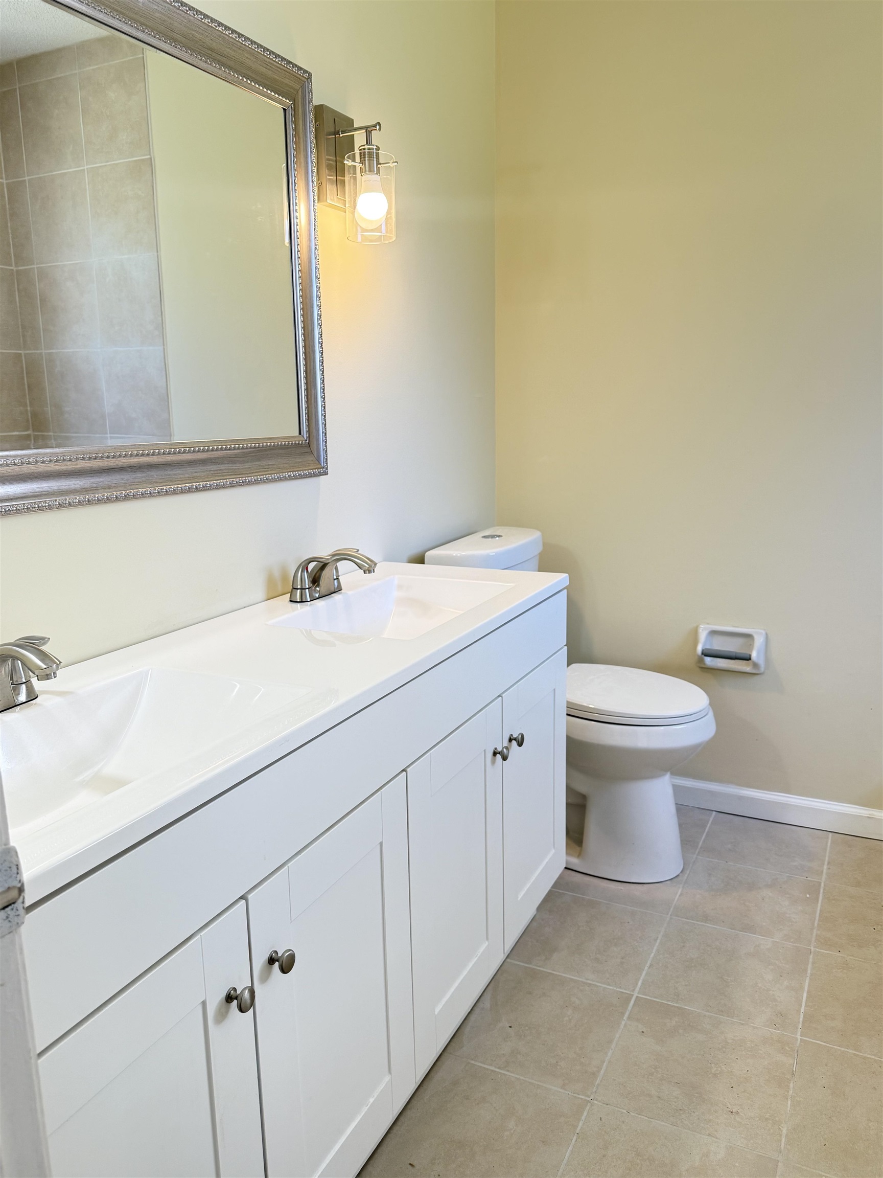 4418 Spring Park Drive Memphis, TN 38141 - Photo 12 of 12 a bathroom with a granite countertop sink and a toilet