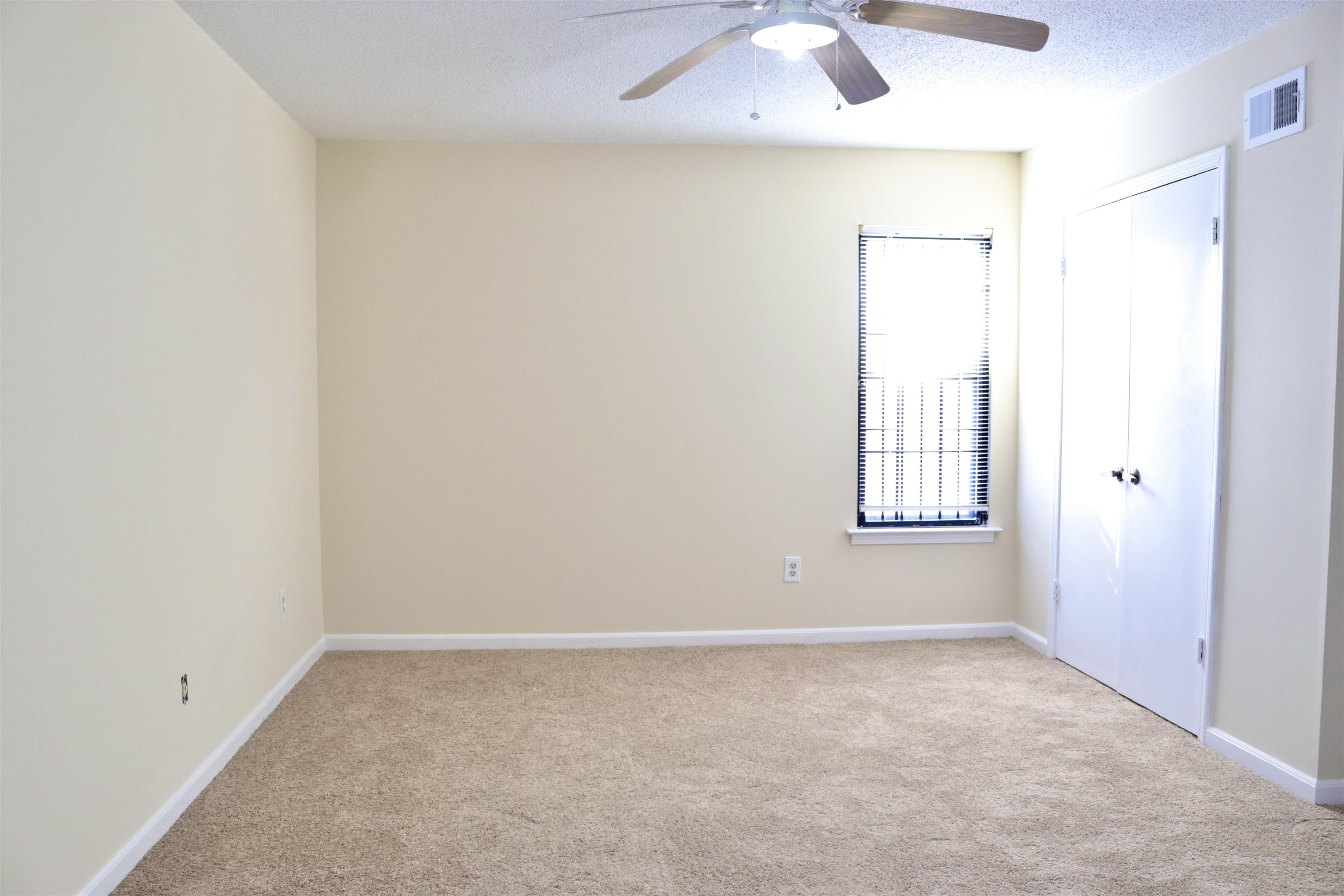 4418 Spring Park Drive Memphis, TN 38141 - Photo 6 of 12 an empty room with a window and a fan