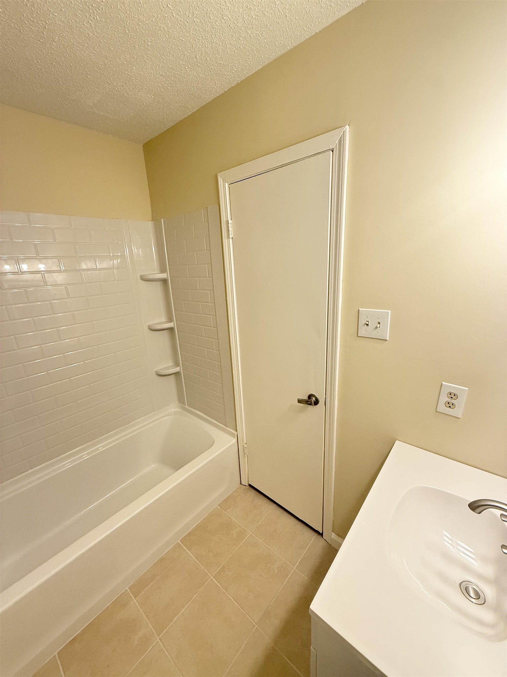 4418 Spring Park Drive Memphis, TN 38141 - Photo 8 of 12 a bathroom with a tub and shower