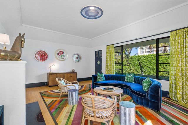 a living room with furniture and a floor to ceiling window