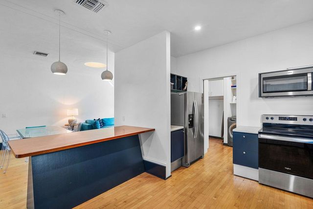 a kitchen with stainless steel appliances a stove a refrigerator and a sink