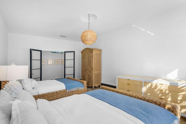 a bedroom with a bed and a chandelier