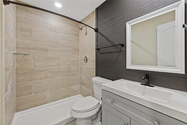 a bathroom with a sink toilet and shower