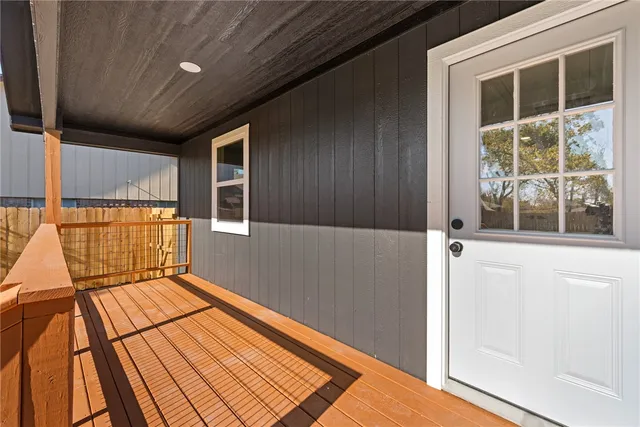 a view of balcony with a floor to ceiling window and wooden floor