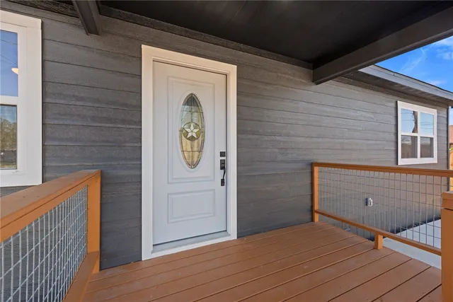a view of a door and wooden floor